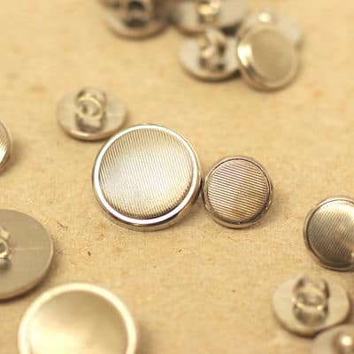 Button with silver metal aspect