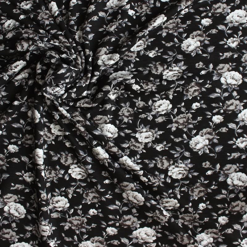 Jersey fabric of viscose and elasthanne with beige flowers on black ...